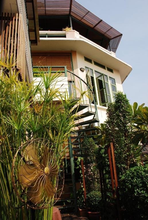 Exterior and balconies beside the river at Arun Residence