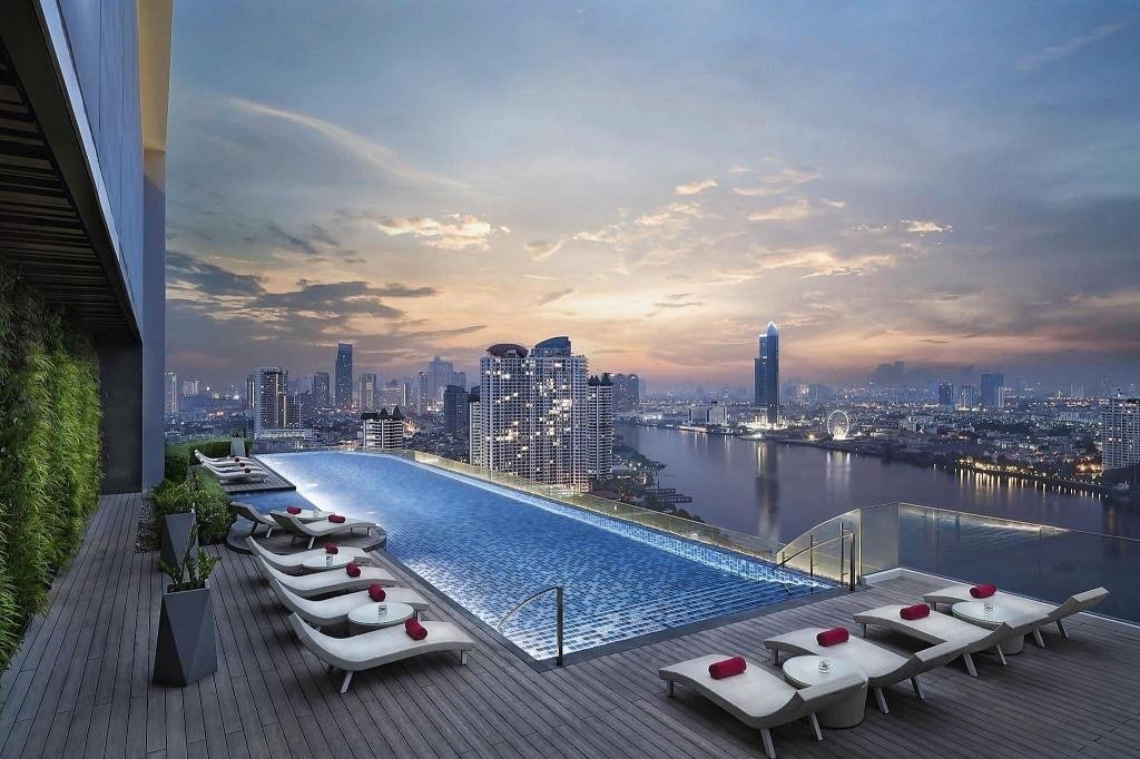 Rooftop swimming pool overlooking the river at Avani+ Riverside Bangkok Hotel