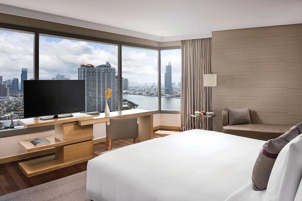 Guest bedroom with river outlook at Avani+ Riverside Bangkok Hotel