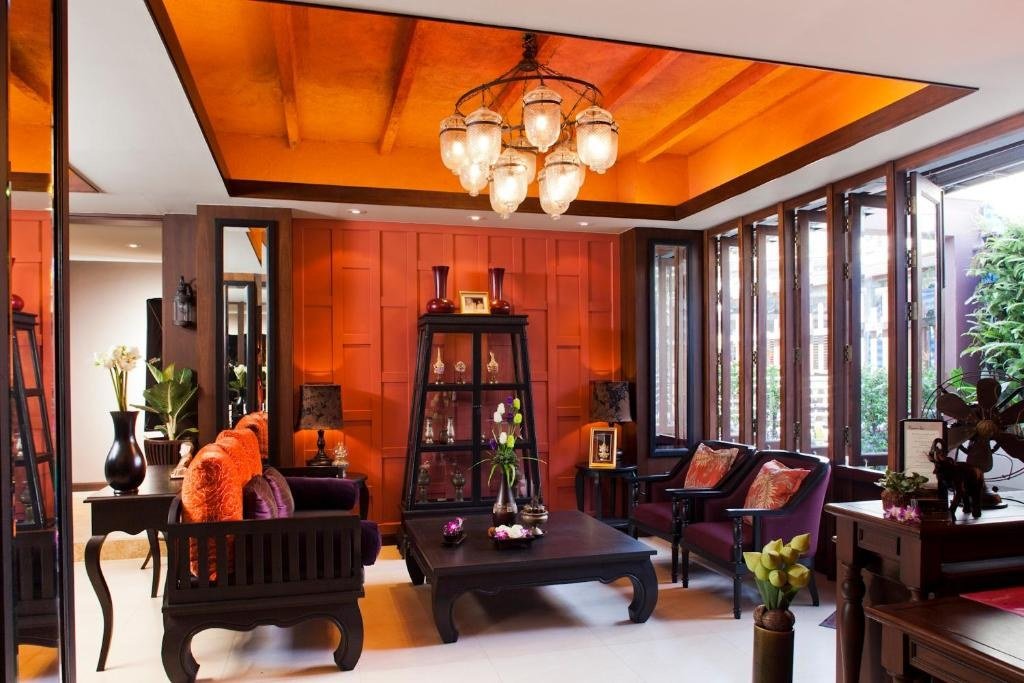 Wood-panelled lounge and seating at Baan Wanglang Riverside