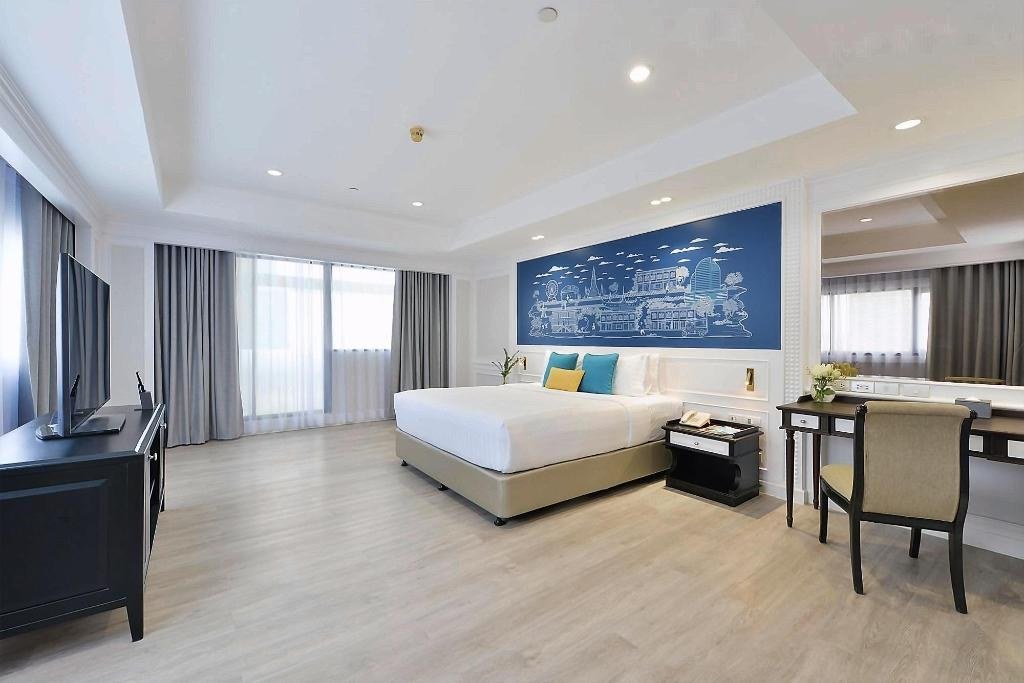 Guest bedroom with wooden floor at Centre Point Plus Hotel Silom