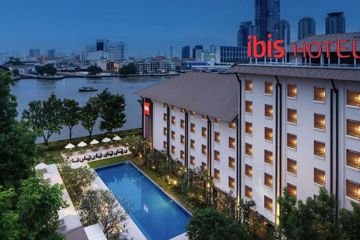 Riverfront hotel building at dusk at ibis Bangkok Riverside