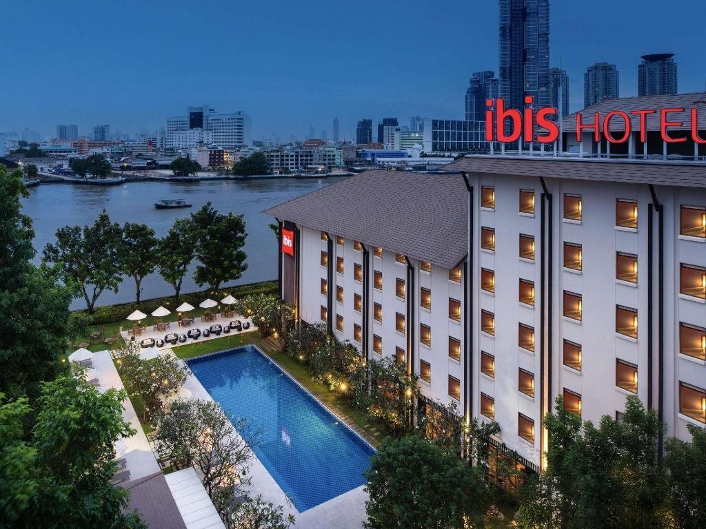 Riverfront hotel building at dusk at ibis Bangkok Riverside
