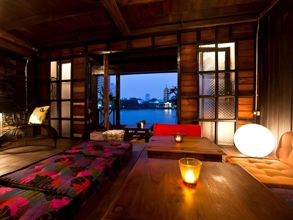 Wood-panelled dining space beside the river at Loy La Long Hotel