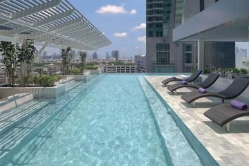 Outdoor swimming pool and sun loungers at Mode Sathorn Hotel