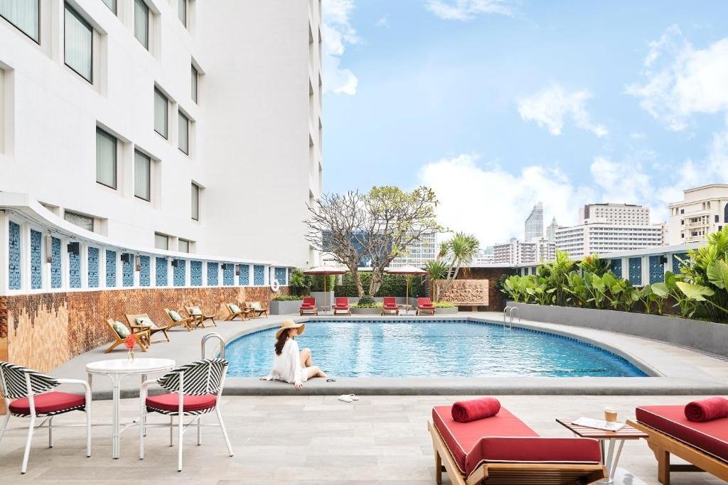 Outdoor swimming pool and sun loungers at Montien Hotel Surawong Bangkok