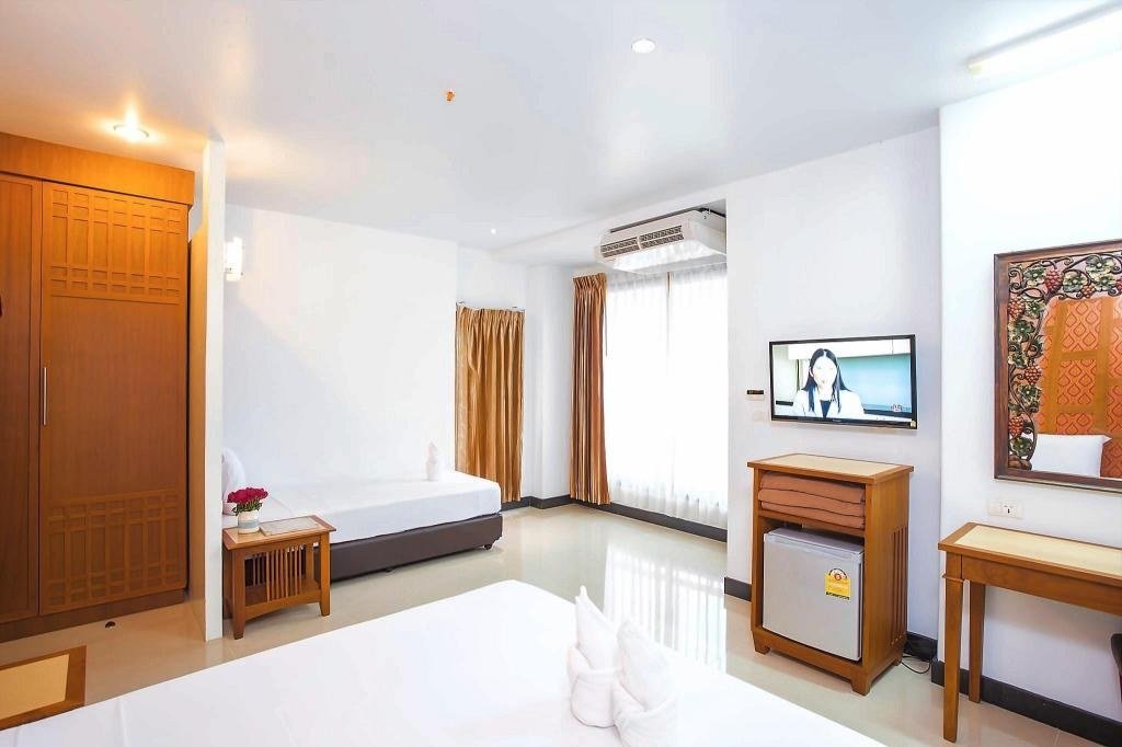 Guest bedroom with balcony at New Siam Palace Ville