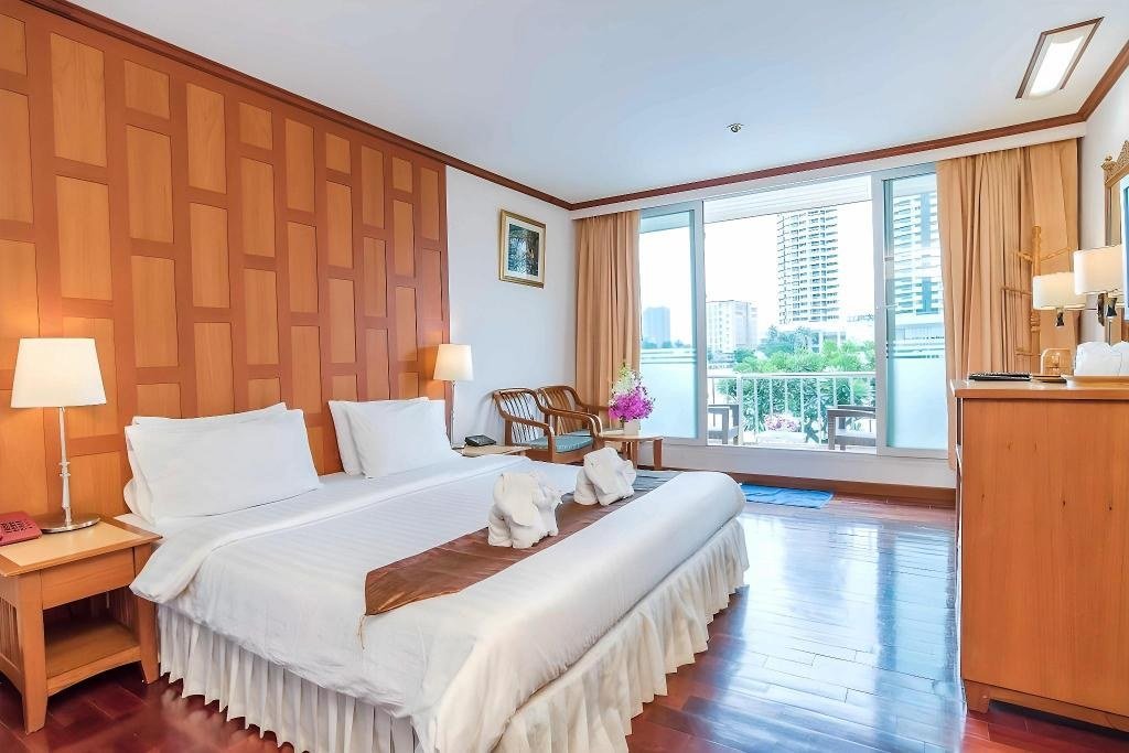 Guest bedroom with balcony at New Siam Riverside