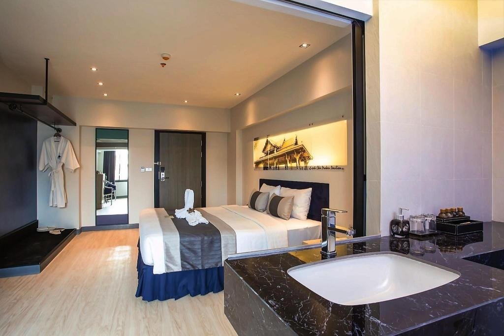 Guest bedroom with seating at Nouvo City Hotel