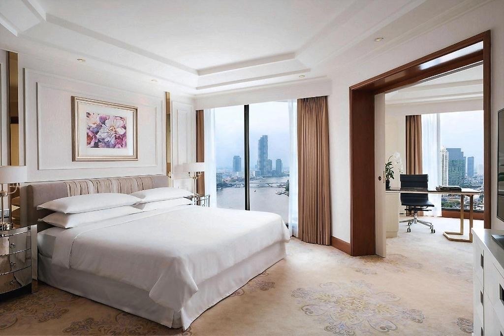 Guest bedroom with city outlook at Royal Orchid Sheraton Riverside Hotel Bangkok