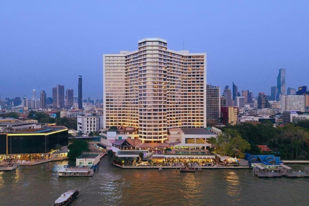 Riverfront hotel building at dusk at Royal Orchid Sheraton Riverside Hotel Bangkok