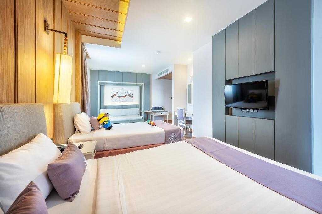 Guest bedroom with padded headboards at Royal Rattanakosin Hotel