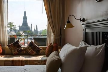 Bedroom with window view toward Wat Arun at Sala Arun
