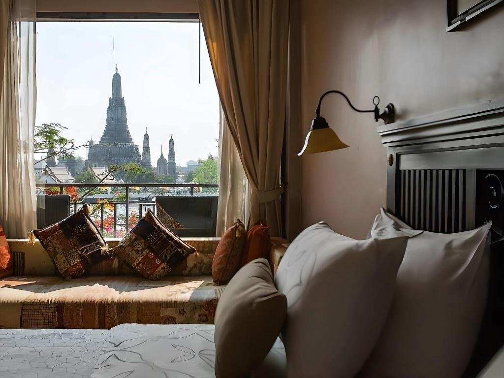 Bedroom with window view toward Wat Arun at Sala Arun