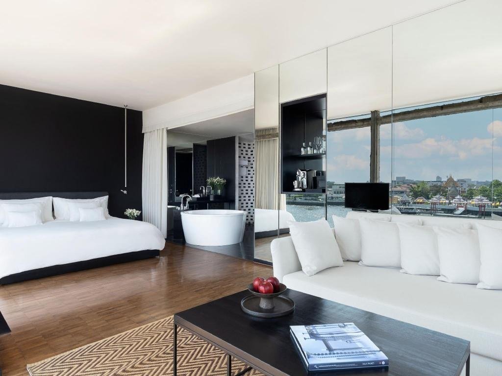 Guest bedroom with seating and bathtub at sala rattanakosin Bangkok