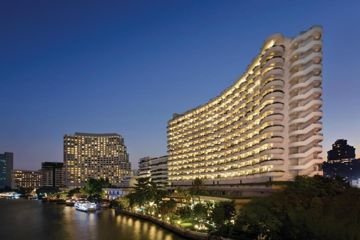 Riverfront hotel building at night at Shangri-La Bangkok