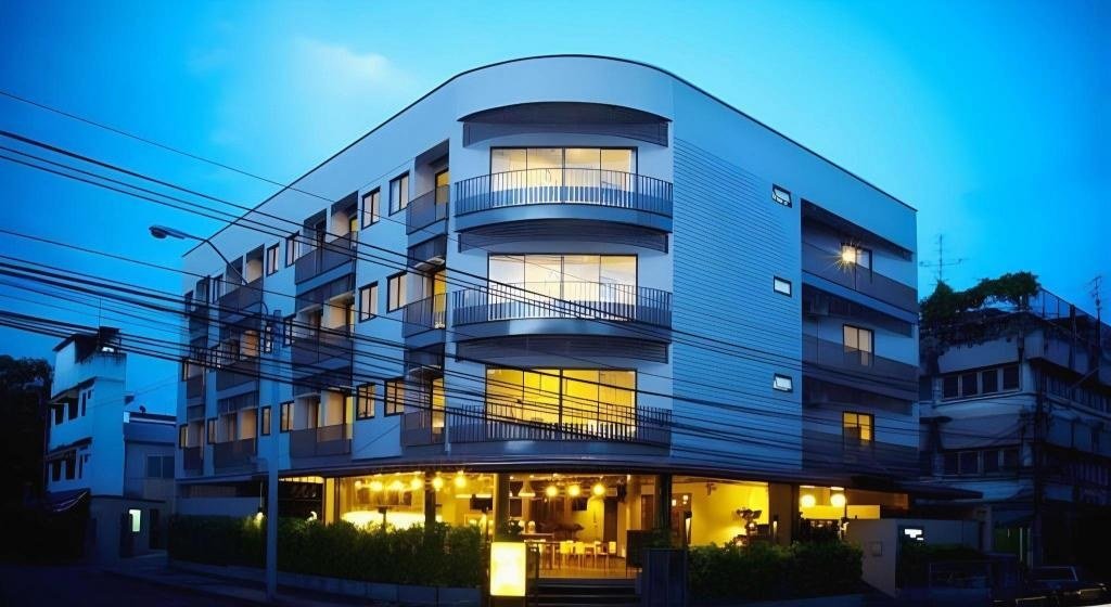 Hotel street facade at dusk at Siri Oriental Bangkok Hotel