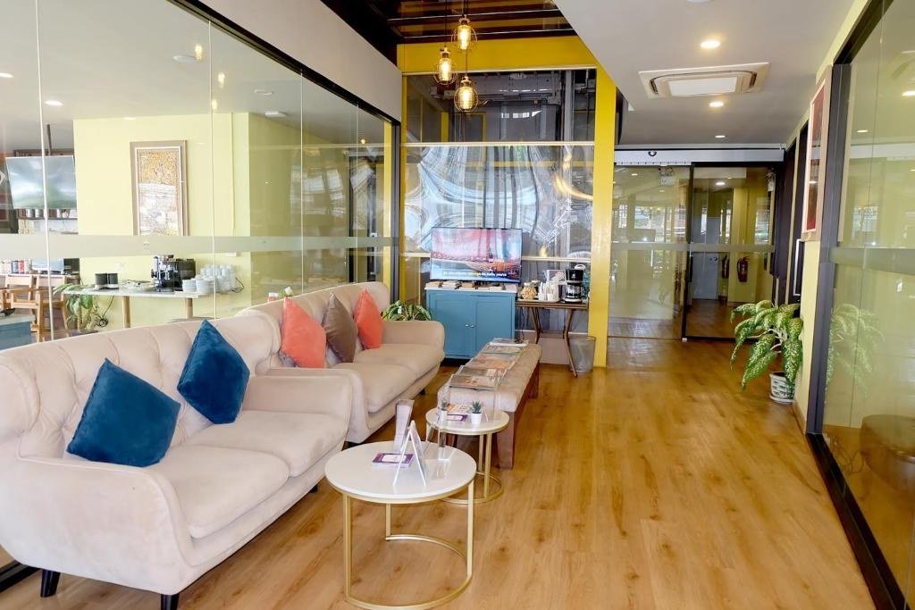 Bright lobby with sofa seating at Siri Oriental Bangkok Hotel