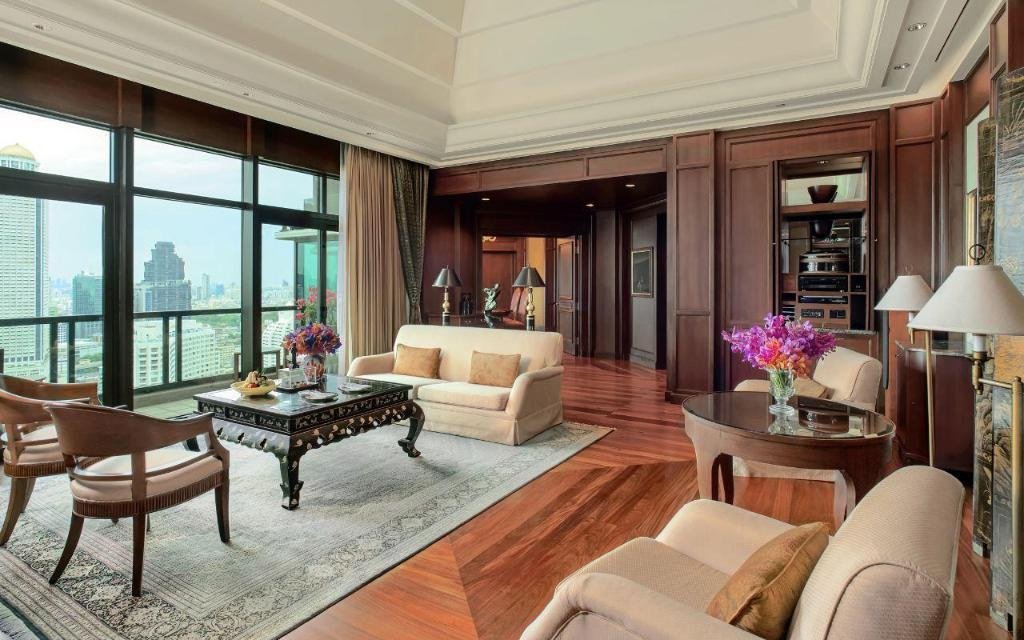 Guest bedroom and river-facing sitting area at The Peninsula Bangkok