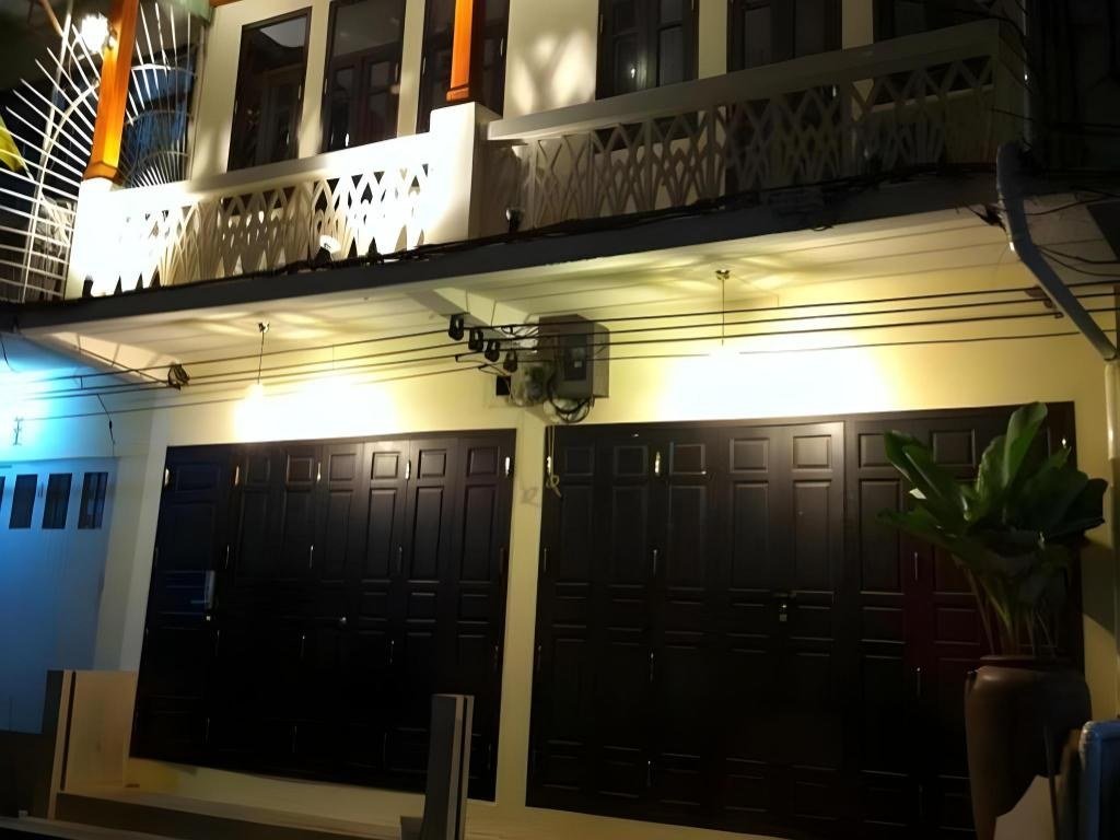 Hotel exterior at night at The Royal ThaTien Village