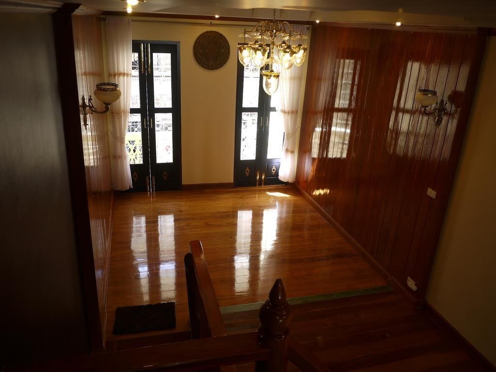 Wood-panelled interior hallway at The Royal ThaTien Village