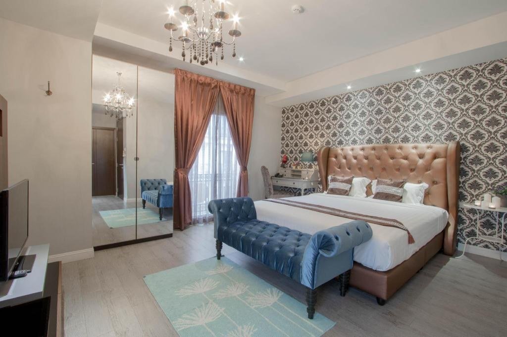 Guest bedroom with patterned walls at The Star of Sathorn