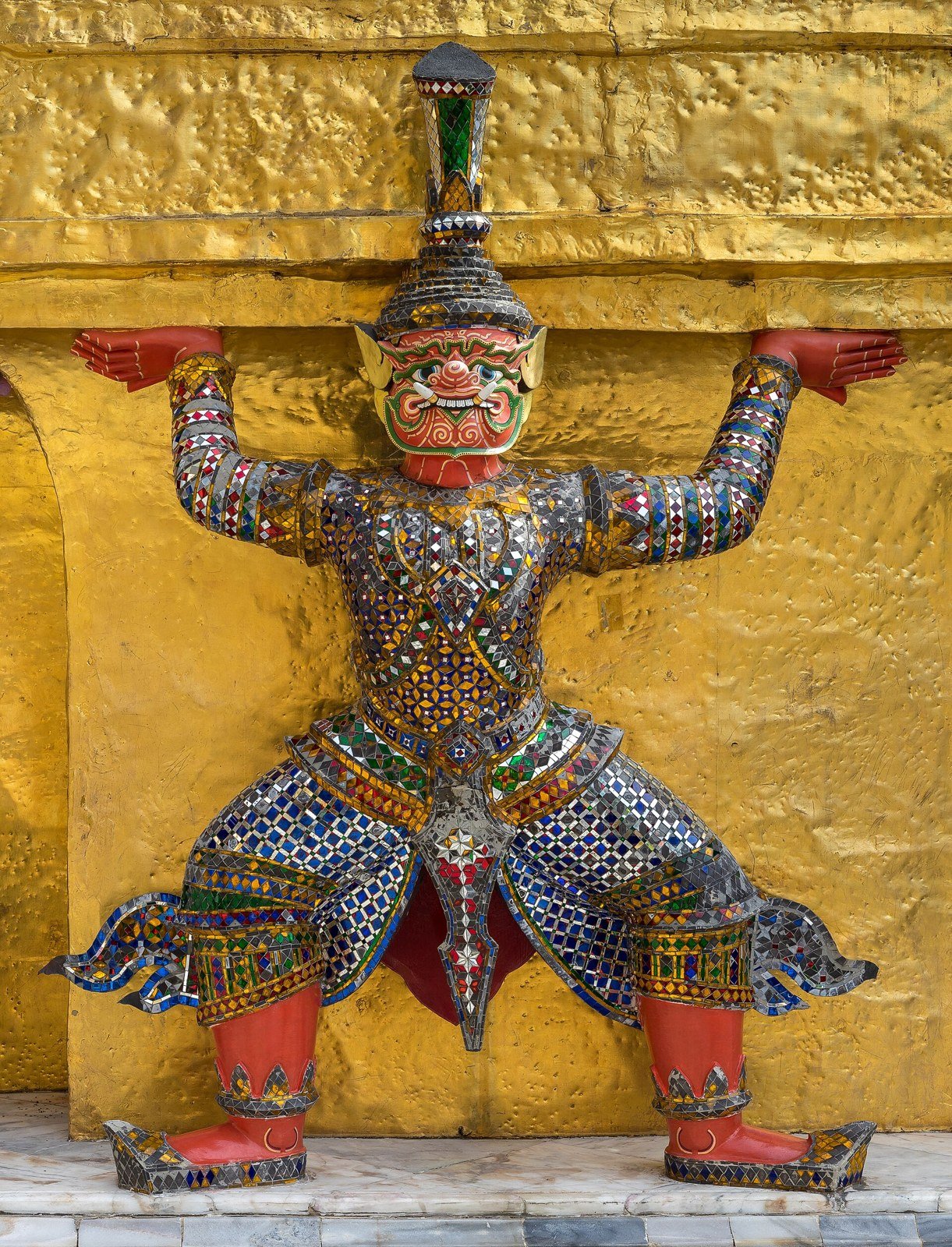 Decorated yaksha statue supporting a chedi at Wat Phra Kaew